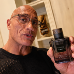 Dwayne Johnson holds a PAPATUI fragrance bottle while teasing a new 2027 scent